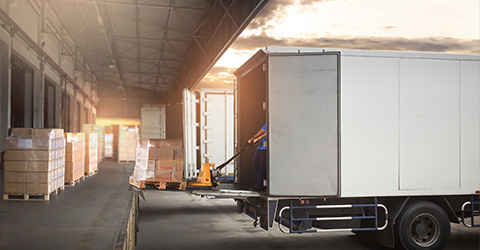 delivery trucks parked in a warehouse for loading and unloading goods showcasing efficient logistics operations seven days a week